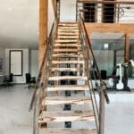 Floating wood stairs in a barndominium office build-out