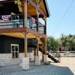Black party barn with cedar pergola entrance