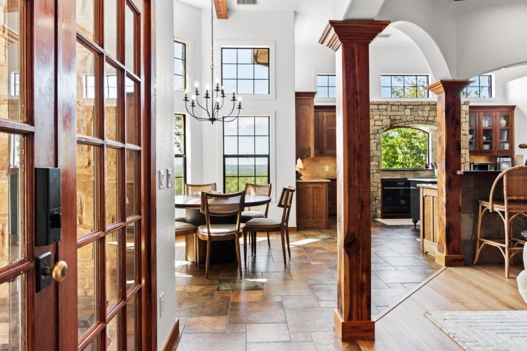 Custom home interior staircase with wood railings in Dripping Springs TX by Ridge Rock Builders