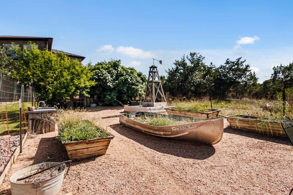 Custom home outdoor garden area with raised planters in Dripping Springs TX by Ridge Rock Builders