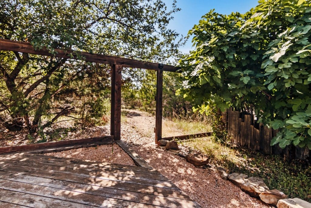 Custom home outdoor deck and landscaping in Dripping Springs TX by Ridge Rock Builders