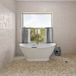 Tiled bathroom with freestanding tub and garden window in a custom Hill Country home