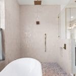 Bright bathroom with soaking tub and brass fixtures in a custom home by Ridge Rock Builders