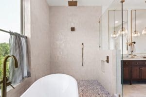 Bright bathroom with soaking tub and brass fixtures in a custom home by Ridge Rock Builders