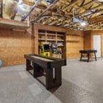 Flex game room with shuffleboard and arcade games inside a casita outbuilding by Ridge Rock Builders