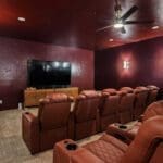 Home theater with large screen and leather recliners in a custom home