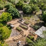 Aerial view of a landscaped backyard with stone paths at a custom Hill Country home