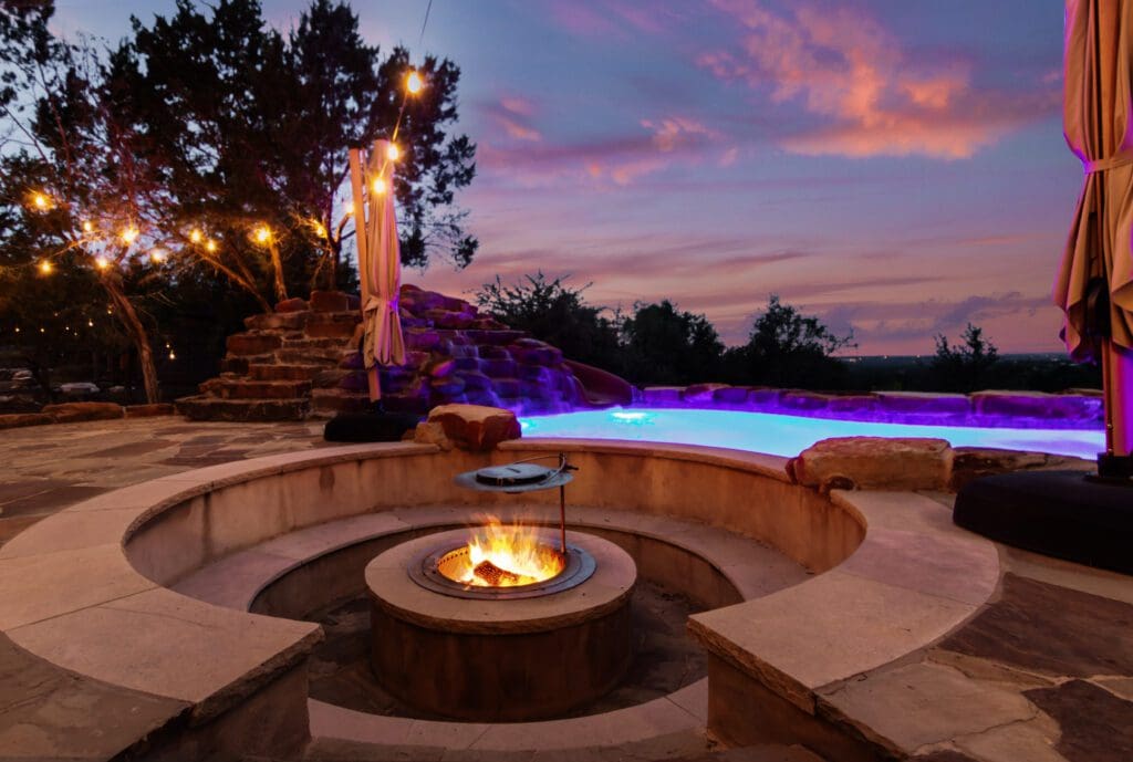 Custom home exterior at twilight in Dripping Springs TX by Ridge Rock Builders