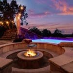 Fire pit and lighted pool at night at a custom Hill Country home