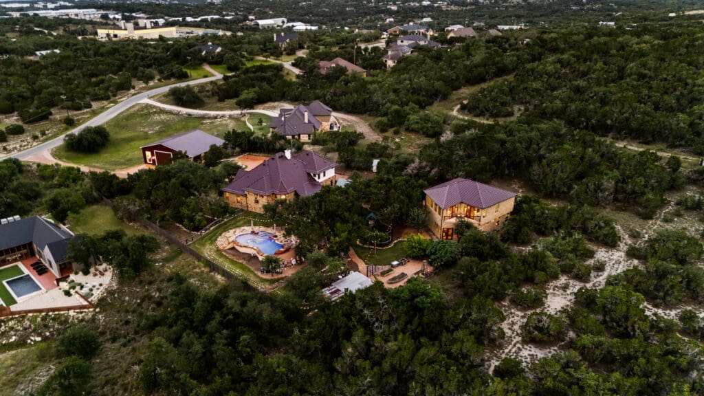 Custom home exterior at twilight in Dripping Springs TX by Ridge Rock Builders