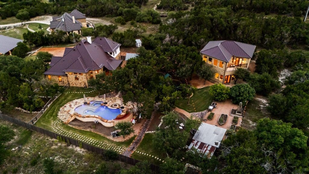 Custom home exterior at twilight in Dripping Springs TX by Ridge Rock Builders