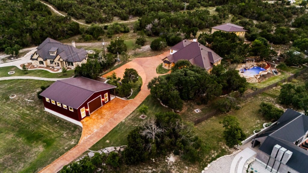 Custom home exterior at twilight in Dripping Springs TX by Ridge Rock Builders
