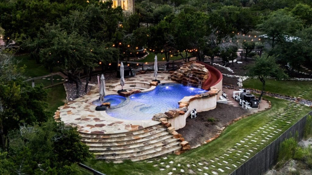 Custom home exterior at twilight in Dripping Springs TX by Ridge Rock Builders