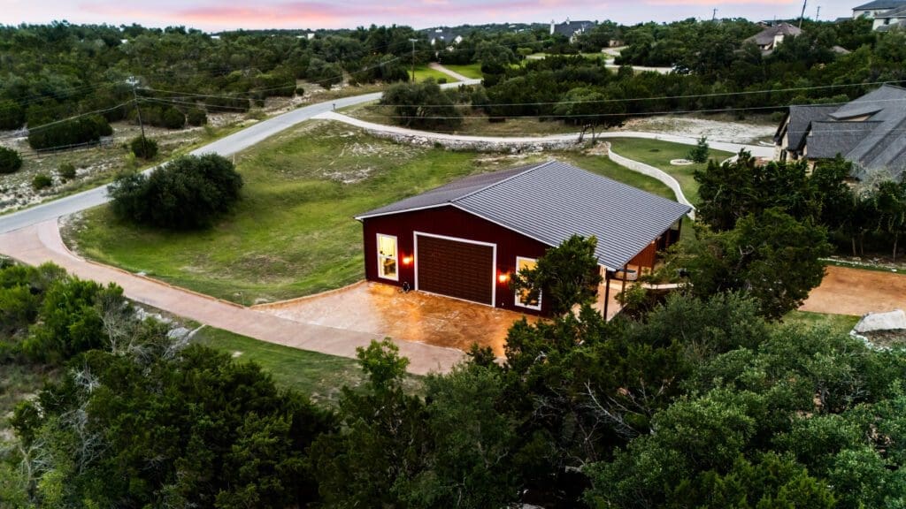 Custom home exterior at twilight in Dripping Springs TX by Ridge Rock Builders