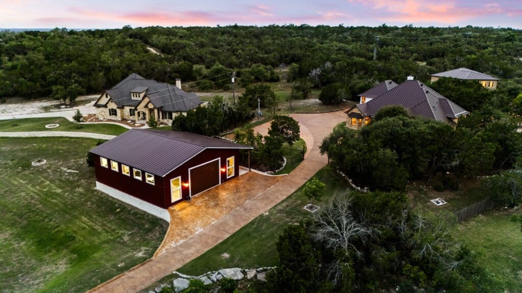 Custom home exterior at twilight in Dripping Springs TX by Ridge Rock Builders