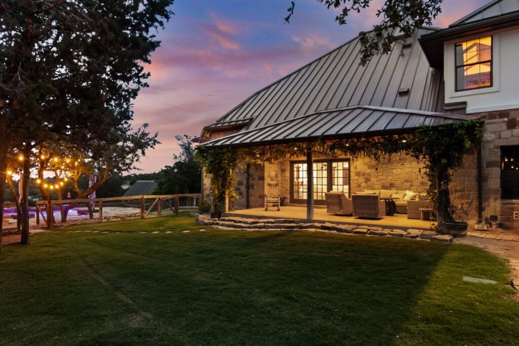 Custom home exterior at twilight in Dripping Springs TX by Ridge Rock Builders