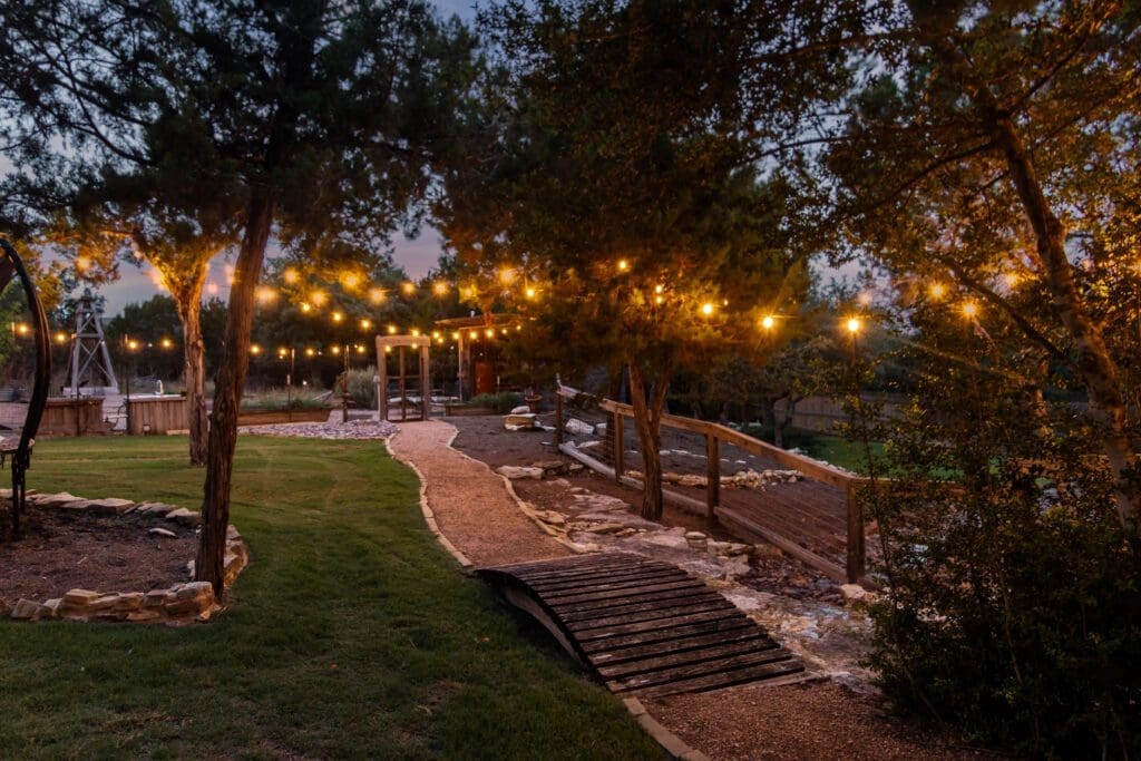 Custom home exterior at twilight in Dripping Springs TX by Ridge Rock Builders